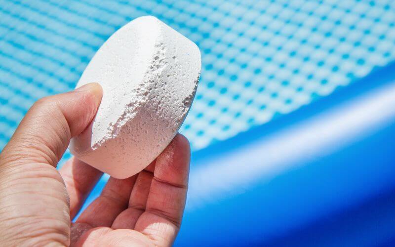 Chlorine Pellets with inflatable pool on background