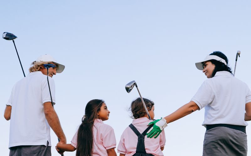 family holding golf club