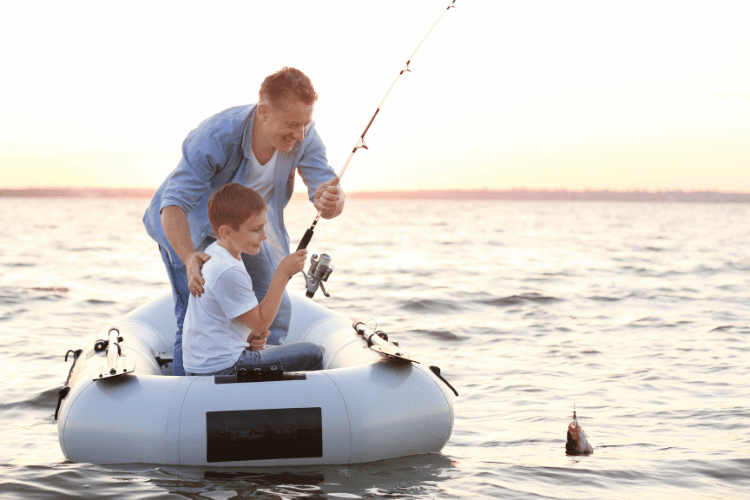 Father and young son in an inflatable boat fishing