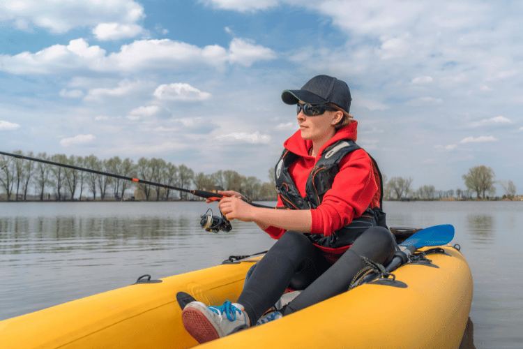 close-up of a fisherwoman on an inflateble boat with fishing tackle