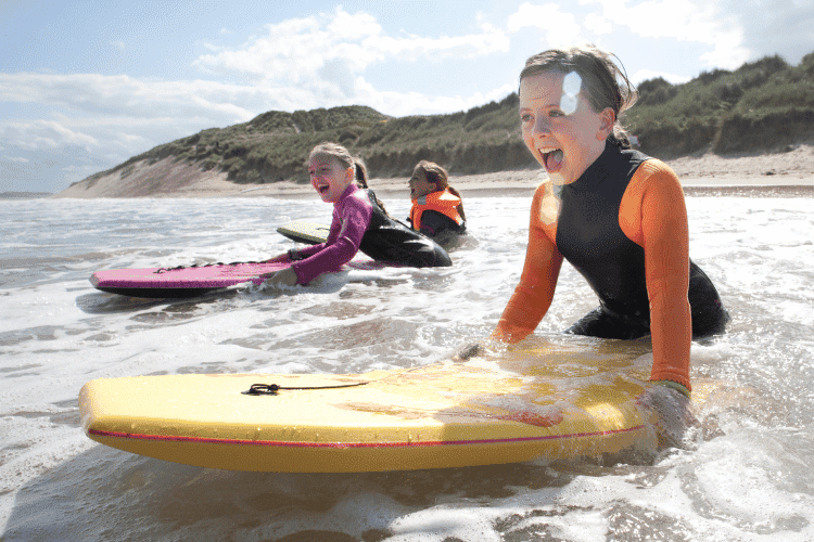 Girls bodyboarding in the sea