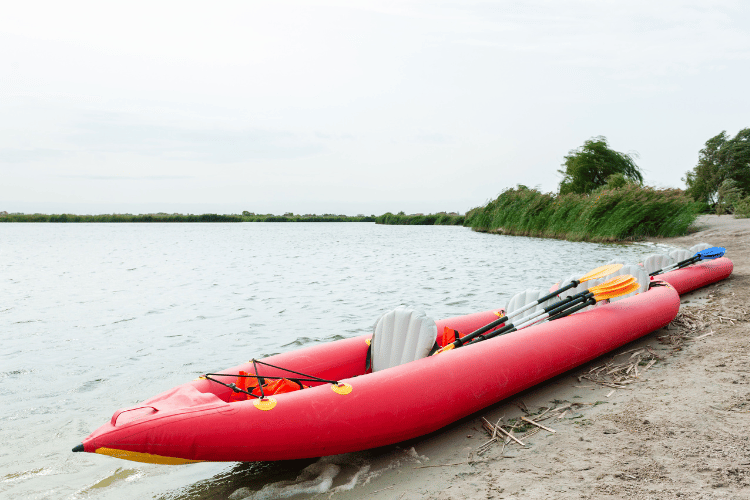 Inflatable red boat kayak at the beach