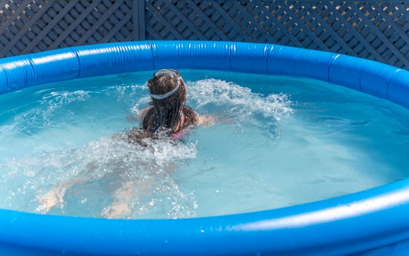Little girl having fun on inflatable pool