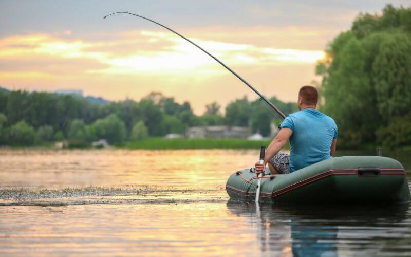 man fishing from inflatable boat