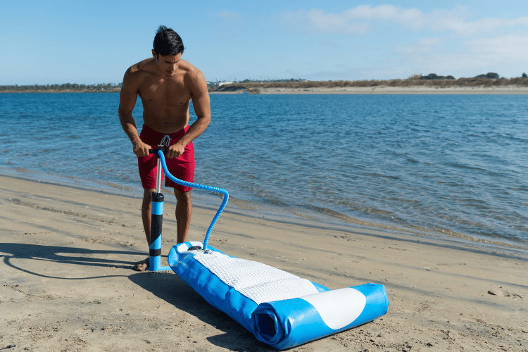 Man Pumping Inflatable Paddle Board