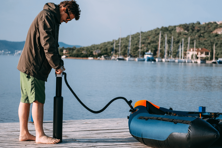 Young Man Preparing His Inflatable Boat