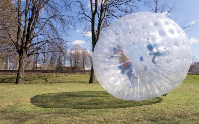 a kid playing zorb ball