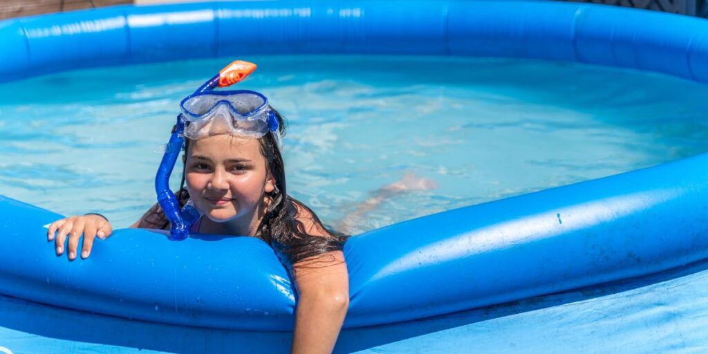 girl swimming in inflatable pool