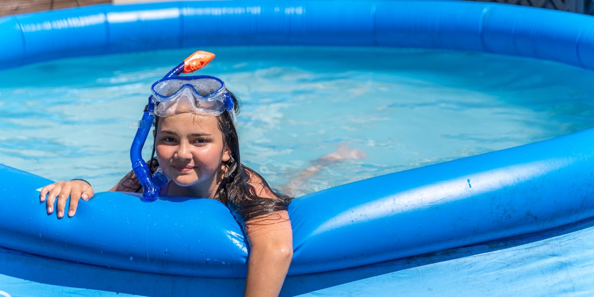 girl swimming in inflatable pool