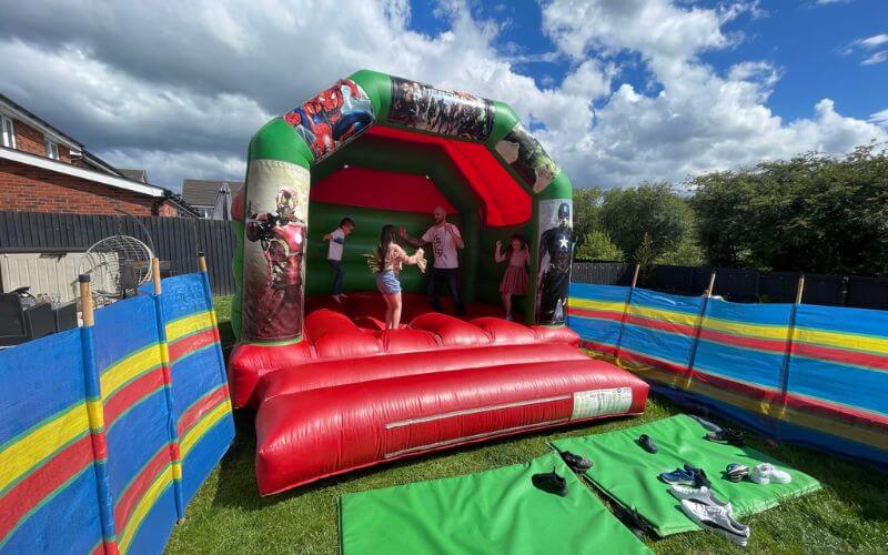 family playing on marvel heroes inflatable bounce house 