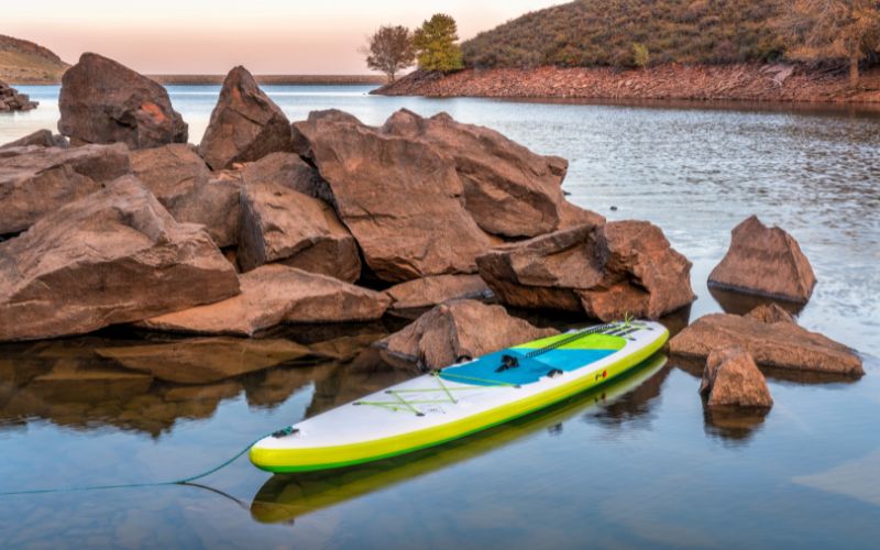 inflatable paddle board on mountain lake