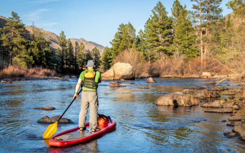 inflatable paddleboard on mountain river