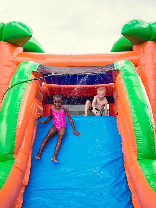 Happy children playing on an inflatable slide