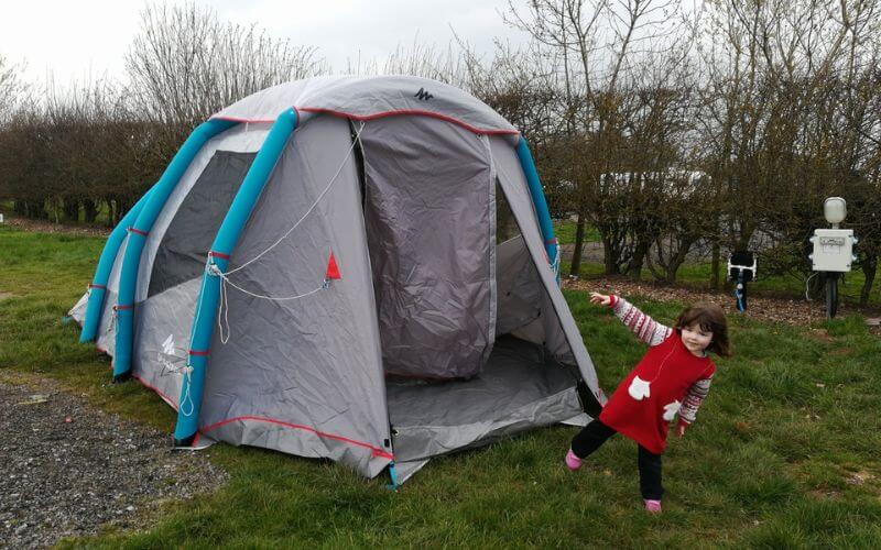 a young girl in front of an inflatable tent