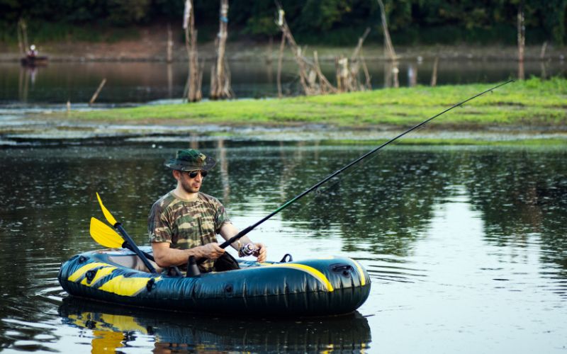 man fishing from inflatable boat