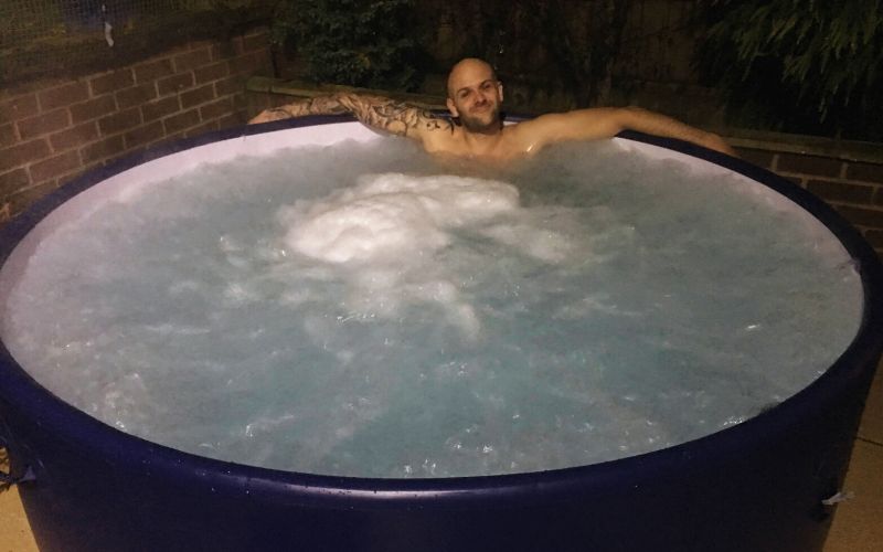 man relaxing in the inflatable hot tub