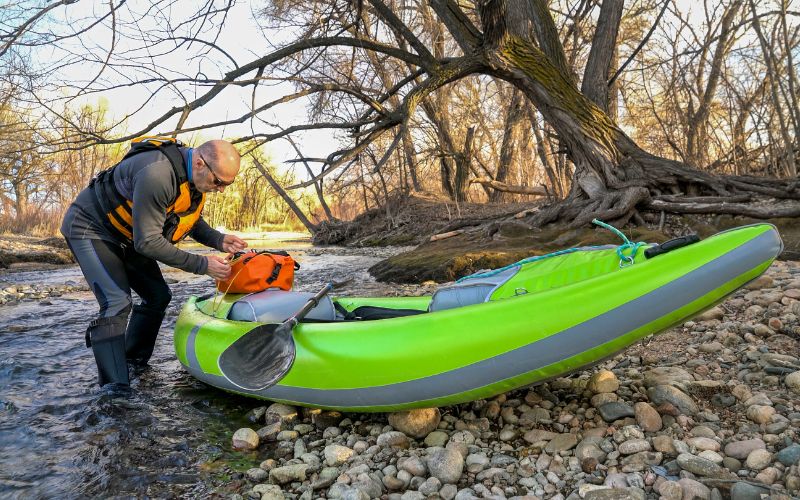 paddler with whitewater inflatable kayak