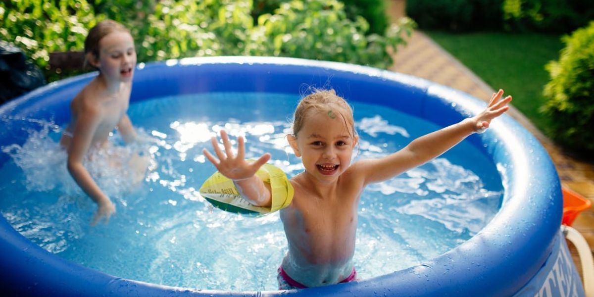 two kids in inflatable pool