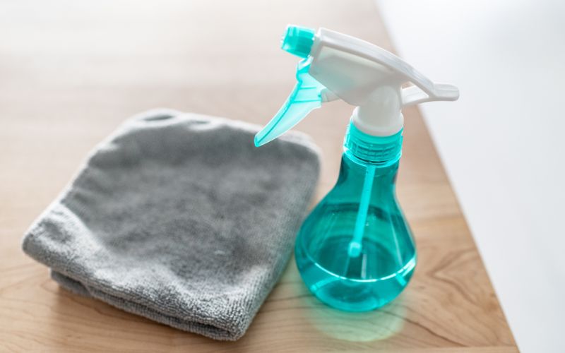 spray bottle and towel on the table